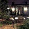 People at a loft party at the end of Blood Alley watching the balcony.